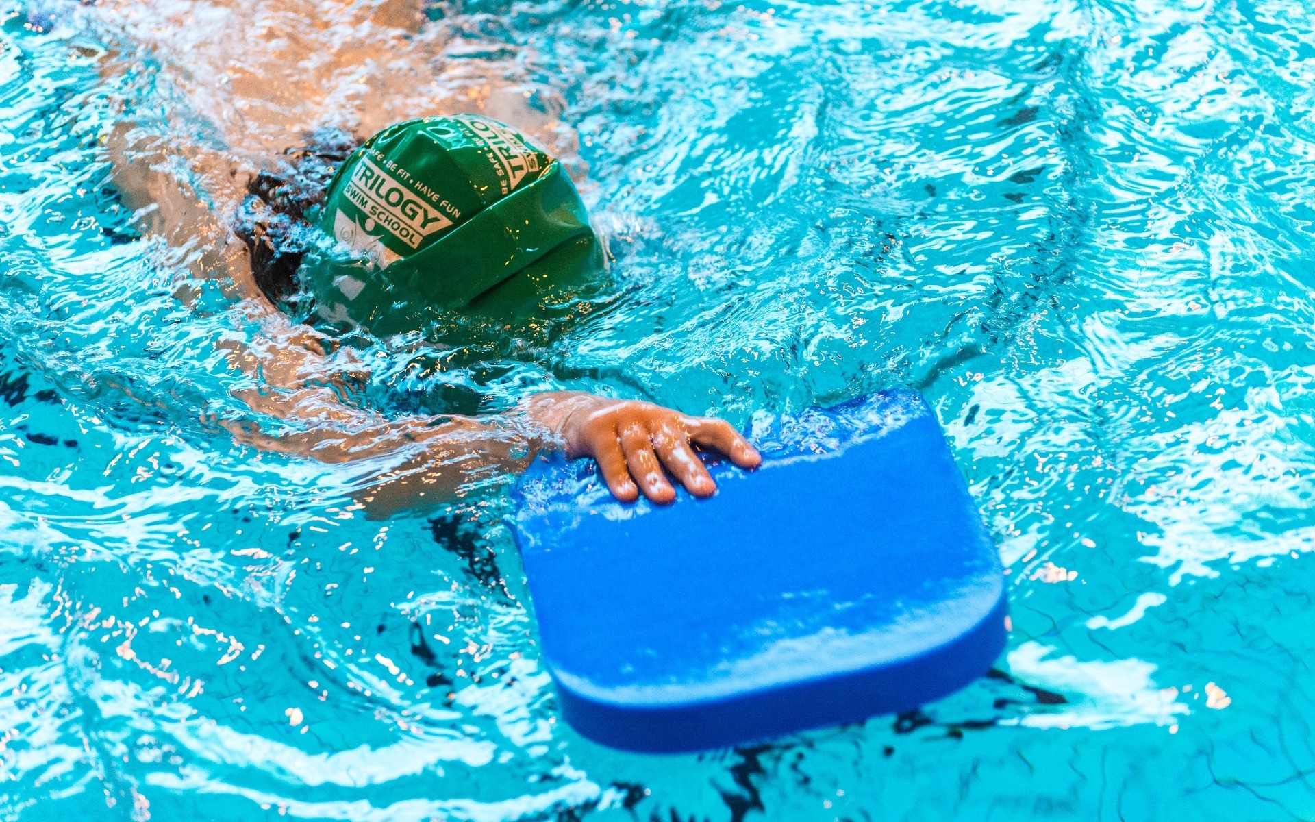 Child swimming lengths with float