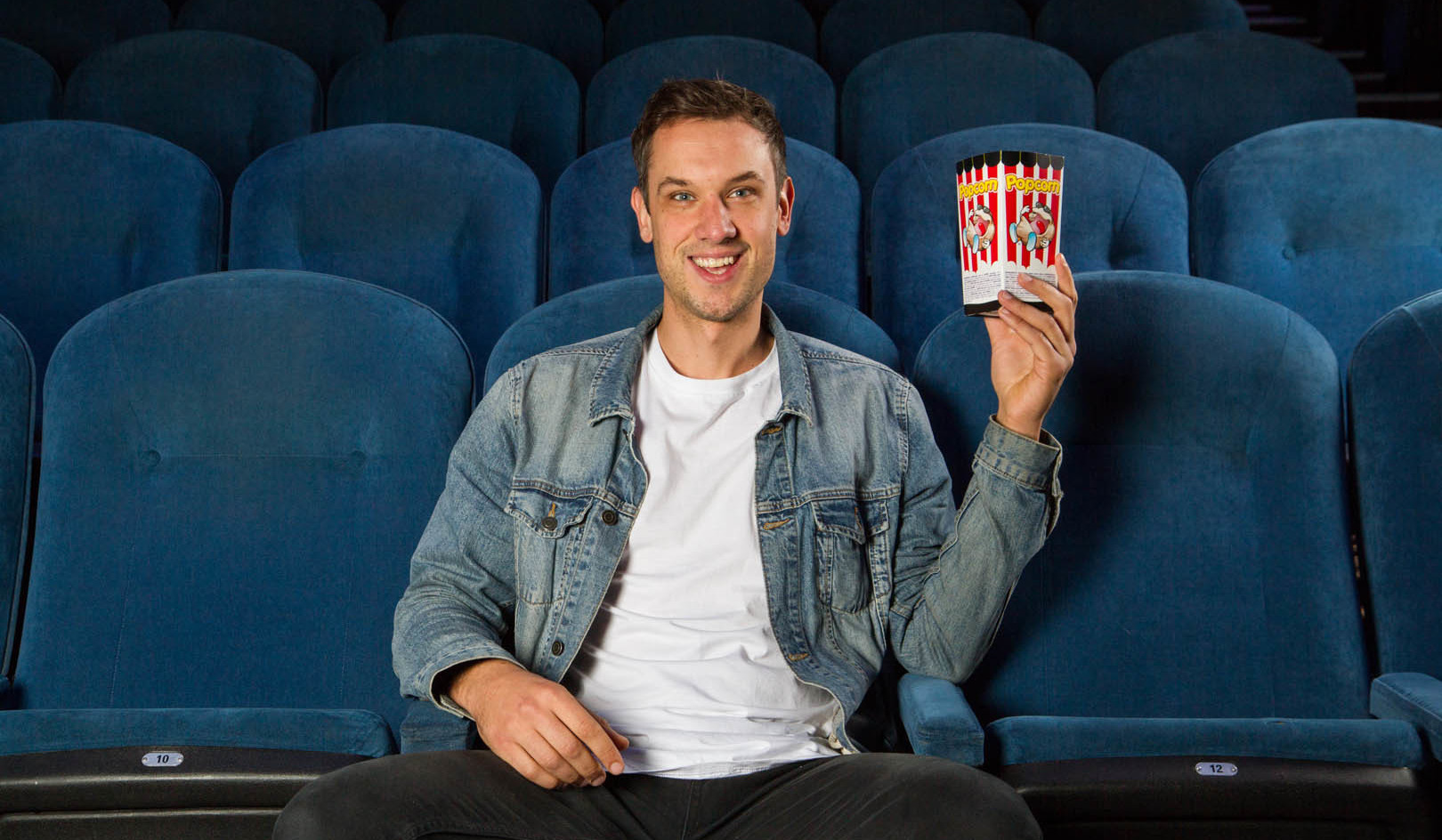 Man in cinema with popcorn